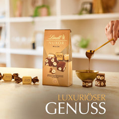 Chocolat Lindt | Sachet de chocolat au lait NUXOR | 103g | Cubes de chocolat au lait crémeux au Gianduja et noisettes grillées | Cadeau chocolat