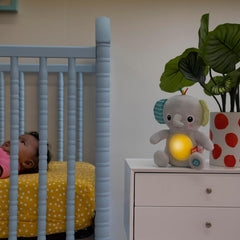 Bright Starts, Hug-a-bye baby elefant de jucărie cu lumini, melodii, texturi diferite și multe altele, multicolor Jucarii Bebe Naty Shop