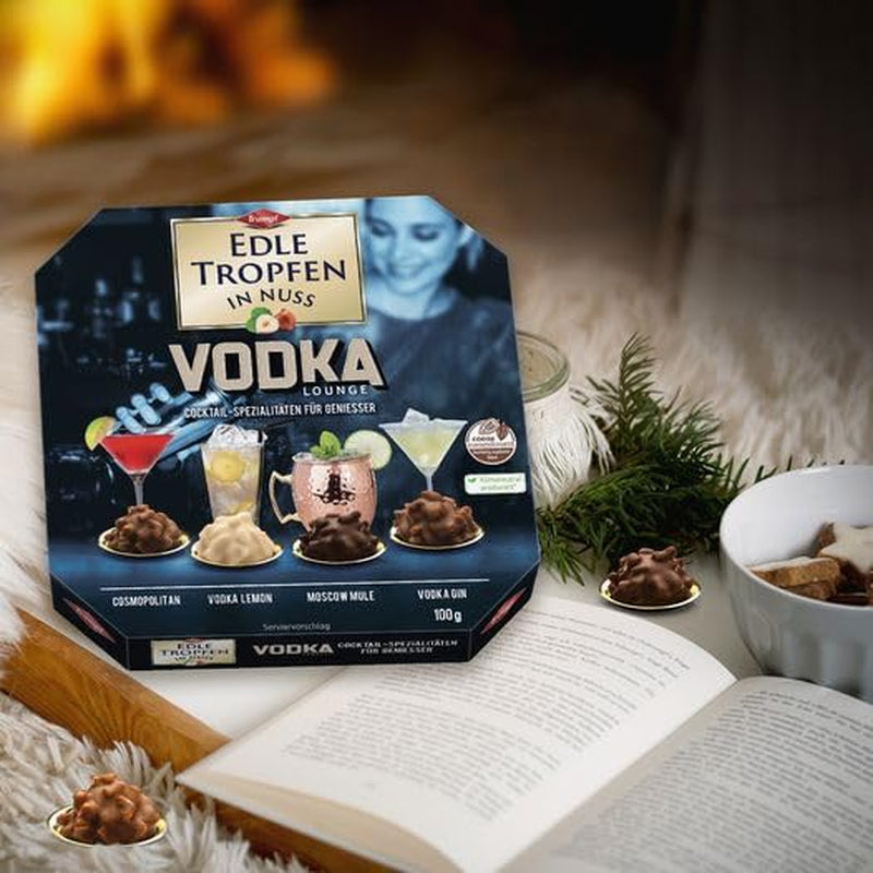 Edle Tropfen in Nuss Vodka Lounge 100g, pralines au chocolat remplies de liquide avec glaçage au chocolat au lait et morceaux croquants de noisette
