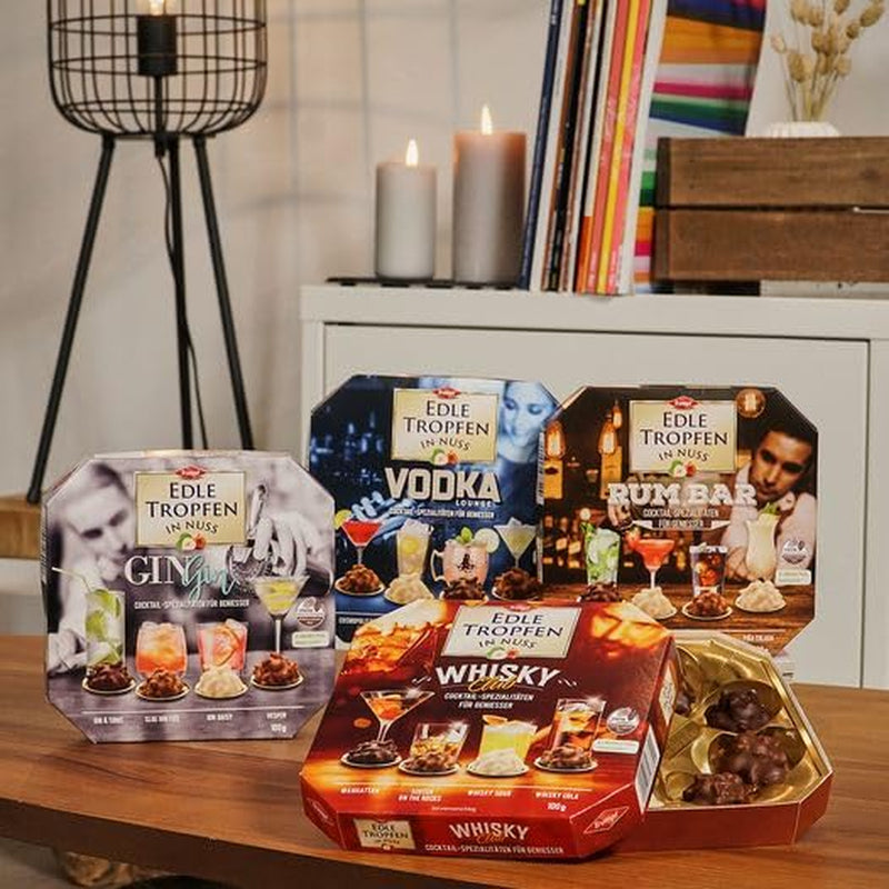 Edle Tropfen in Nuss Vodka Lounge 100g, pralines au chocolat remplies de liquide avec glaçage au chocolat au lait et morceaux croquants de noisette